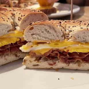 Breakfast sandwich with egg, cheese, and bacon on an everything bagel