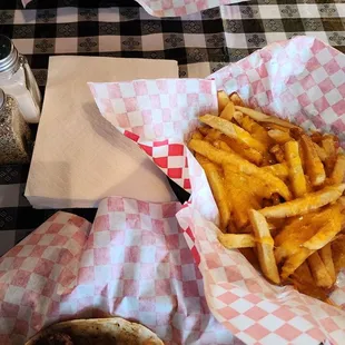 Bottom: cheeseburger taco, cheese fries- top: grilled onion taco with Parm fries