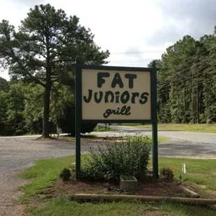 a sign for fat juniors grill