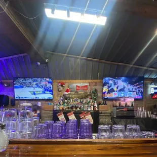 2 TVs behind bar.