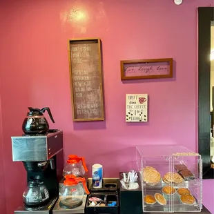 a coffee maker and pastries on a table