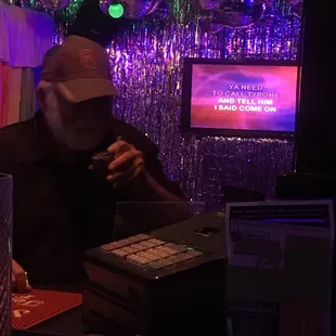  a man sitting at a table in front of a tv