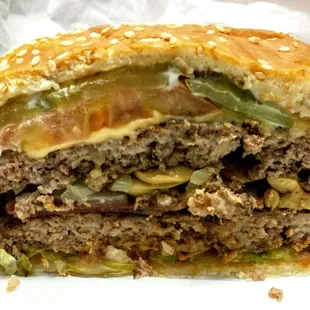 Deluxe burger sliced in half.