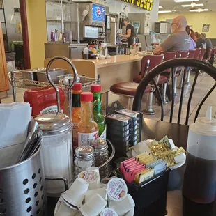 Table full of silverware, condiments, etc.