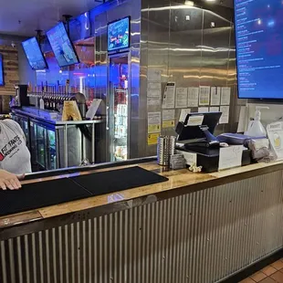 a man standing at a counter in a restaurant