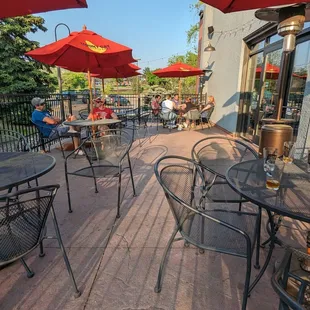 Outdoor patio with a handful of umbrella-shaded tables