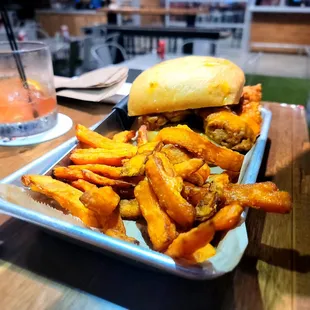 Spicy chicken tender sandwich with sweet potato fries