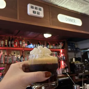 a person holding a glass of coffee