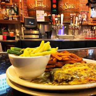 Chop steak smothered in New Mexico green chili,  sweet potato fries, and vegetables.