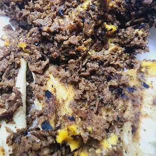Philly cheese steak sandwich with hard burnt grill scrapings mixed throughout the meat