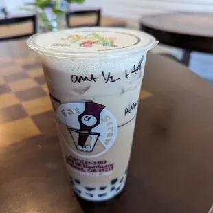 a drink in a plastic cup on a table