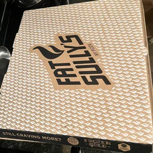 a pizza box on a stove