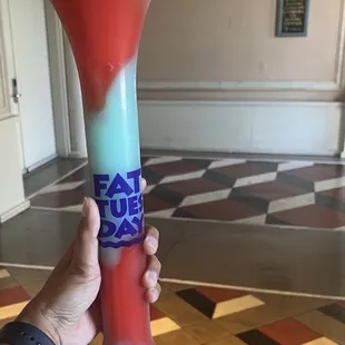 a hand holding a drink