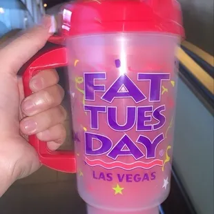 a hand holding a plastic cup