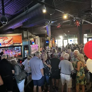 a crowd of people at a bar