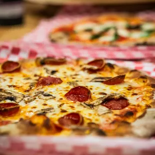 two pizzas on a table