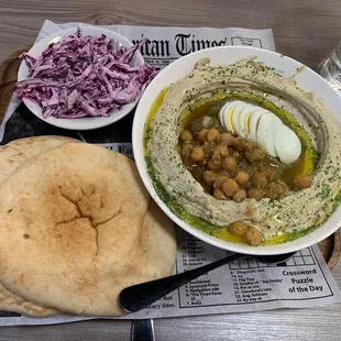 a bowl of hummus and pita bread
