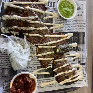 Pita Lachmajoon - seasoned beef on pita bread and grilled.  Matboocha and green Schoog.