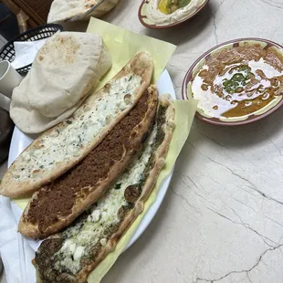 a plate of pita bread and a bowl of dip