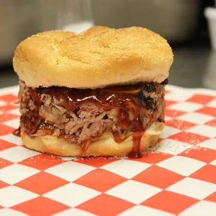 Our pulled pork sandwich. Cooked slow and low, piled high and dripping with your choice of sauce!