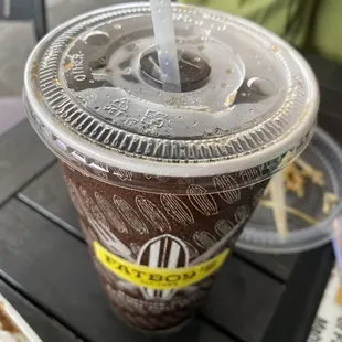a plastic cup with a straw on a table