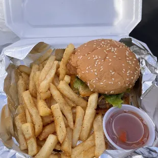 a hamburger and french fries with ketchup