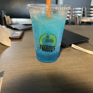 a blue drink in a plastic cup