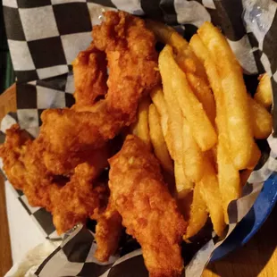 a basket of fried fish and fries