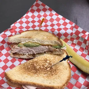 a half eaten sandwich with a pickle