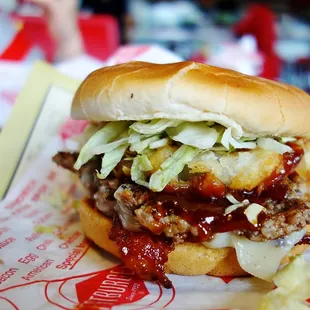 BBQ burger with bacon, onion ring and BBQ sauce.