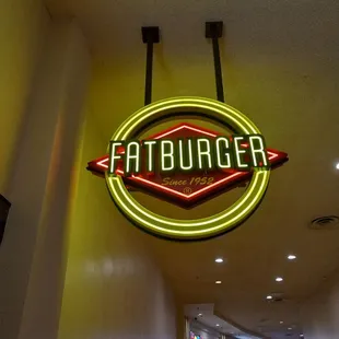 a neon sign for fatburger