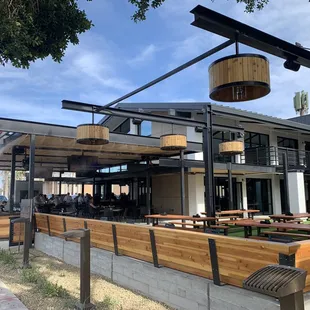 Walking up to front featuring beer garden and outdoor patio