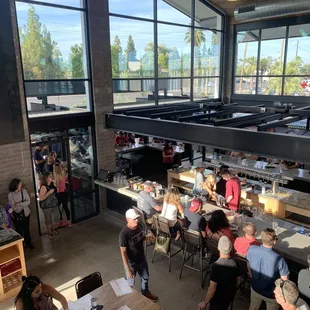 Looking down from loft area to the indoor/outdoor wrap around bar and host stand.