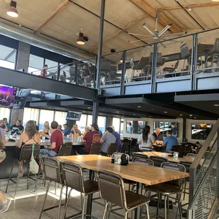 Looking inward of restaurant from host stand. Featuring indoor/outdoor wrap around, indoor dining and upstairs loft for dining.