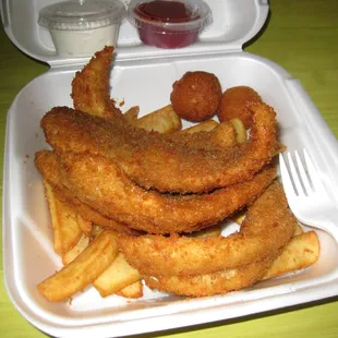fried trout dinner (with fries, hushpuppies, tartar sauce, and ketchup)