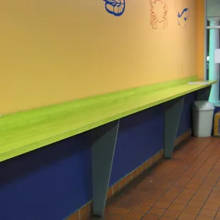the long counter on the right of the store (where patrons stand and eat their food)
