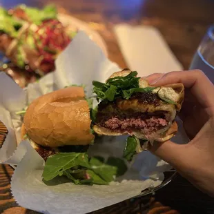 a hand holding a hamburger