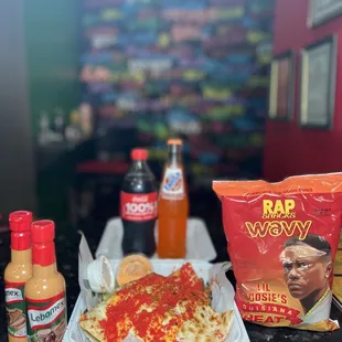 a plate of pizza and a bag of chips