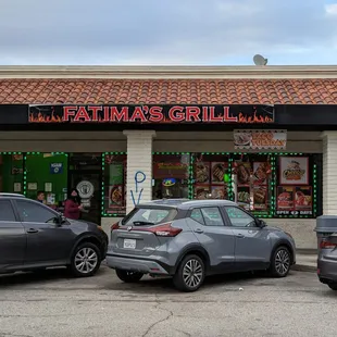 cars parked in front of a restaurant