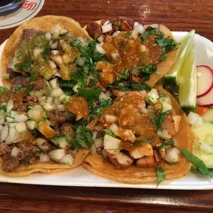 a plate of tacos with meat and vegetables