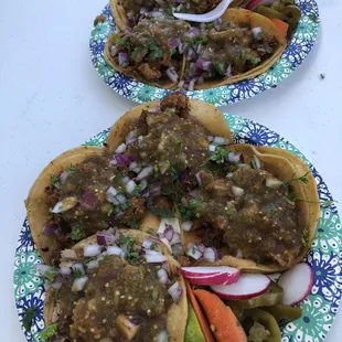 two plates of tacos on a table
