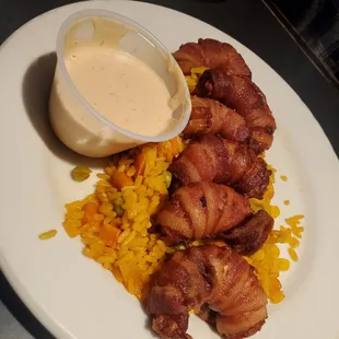 Bacon wrapped shrimp on a bed of rice