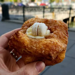 Strawberry jam filled puff with a macaron on top.