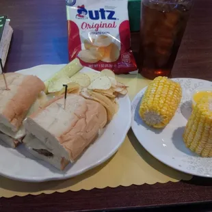 a sandwich and corn on the cob