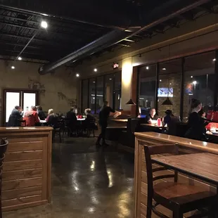 people sitting at tables in a restaurant