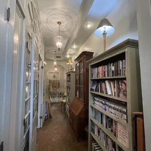 Hall outside the main floor of the bookstore.  Shelves of books  in this area as well.