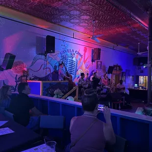 a group of people sitting at a bar