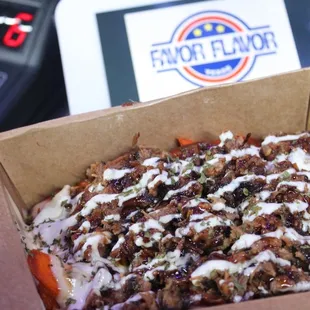 a pizza in a box with toppings