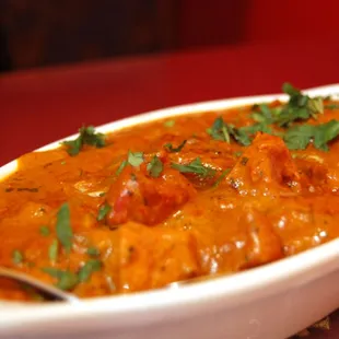 a bowl of curry and a sandwich