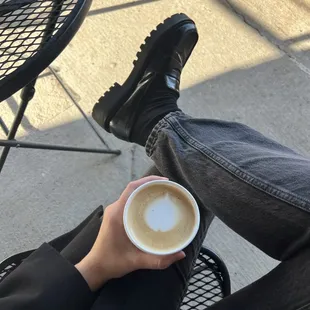 a person holding a cup of coffee